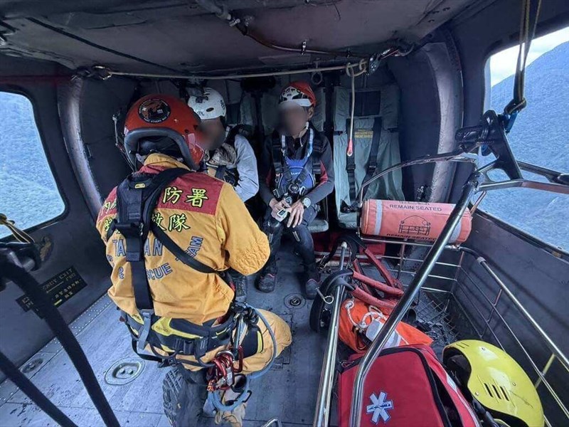 Two tourists stranded on a sandbank board a Ministry of the Interior helicopter in Nantou County on Wednesday. Photo courtesy of the local authority.