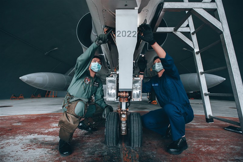 A pilot (left) and aircraft maintenance personnel (right) conduct a pre-flight inspection on a Mirage 2000 fighter jet. File photo courtesy of the Military News Agency