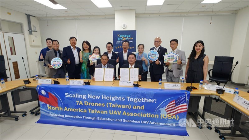 Representatives from 7A Drones (Taiwan) and the North America Taiwan UAV Association pose with a signed MOU on Friday. The agreement was witnessed by Chiayi County Magistrate Weng Chang-liang (back row, fifth from right). CNA photo Sept. 18, 2026.