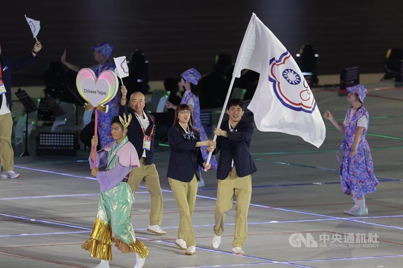 Taiwan's Huang Hsiao-wen (center-left) and Zhang Huan-yi (center-right) carry the Chinese Taipei Olympic flag at the Asian Games opening ceremony in Nagoya on Saturday. CNA photo Sept. 19, 2026