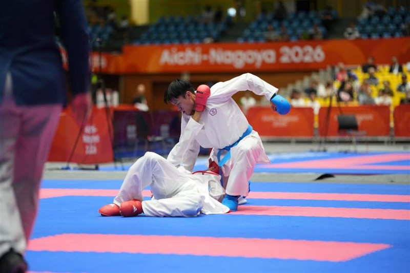 Taiwanese karate athlete Shih Cheng-chung (right, in blue gloves) pins his opponent to the ground during Monday's competition. Photo courtesy of the Chinese Taipei Olympic Committee
