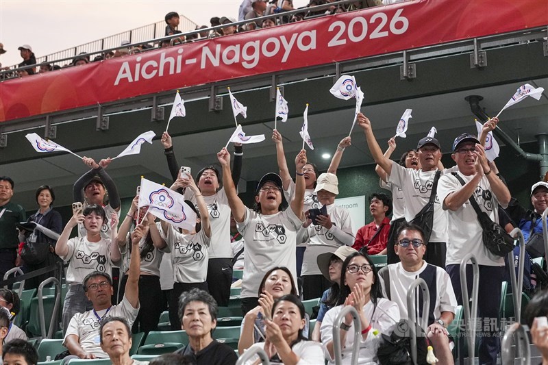 Fans wave Chinese Taipei Olympic flags and cheer after the two Taiwanese players bag gold in the soft tennis mixed doubles at the Asian Games in Nagoya on Monday. CNA photo Sept. 21, 2026