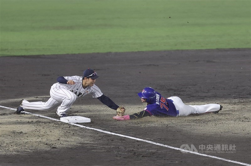 Taiwan's Chen Hsiao-yun (right) is tagged out while attempting to advance to third base during the Asian Games baseball super round match against host Japan on Saturday. CNA photo Sept. 26, 2026
