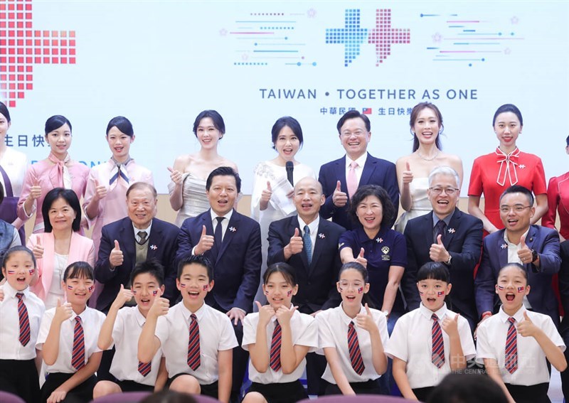 Members of the National Day Preparatory Committee pose with students at a Friday press conference. CNA photo Oct. 2, 2026
