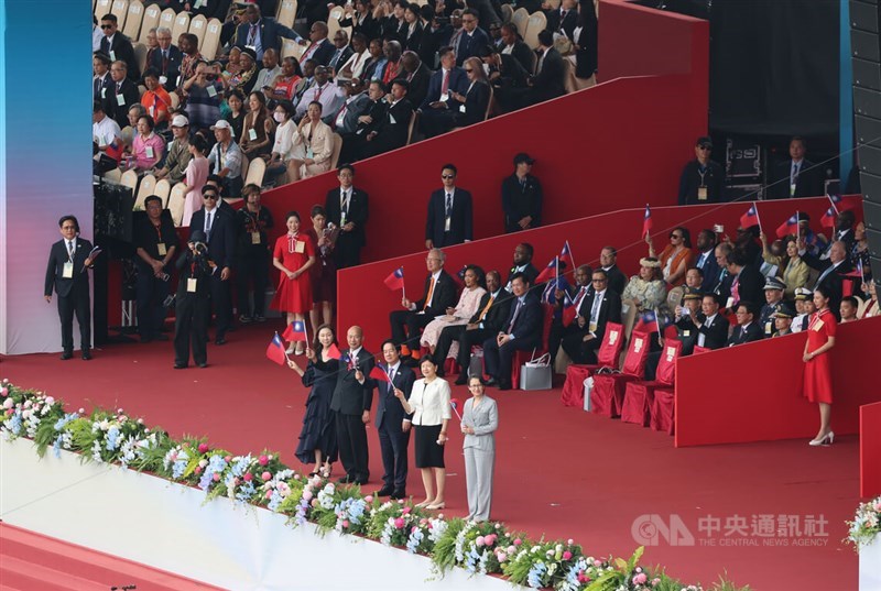 President Lai Ching-te (front, third right), Vice President Hsiao Bi-khim (front, right) and Legislative Speaker Han Kuo-yu (front, second left) wave national flags to the crowd during National Day celebrations in Taipei on Saturday. CNA photo Oct. 10, 2026