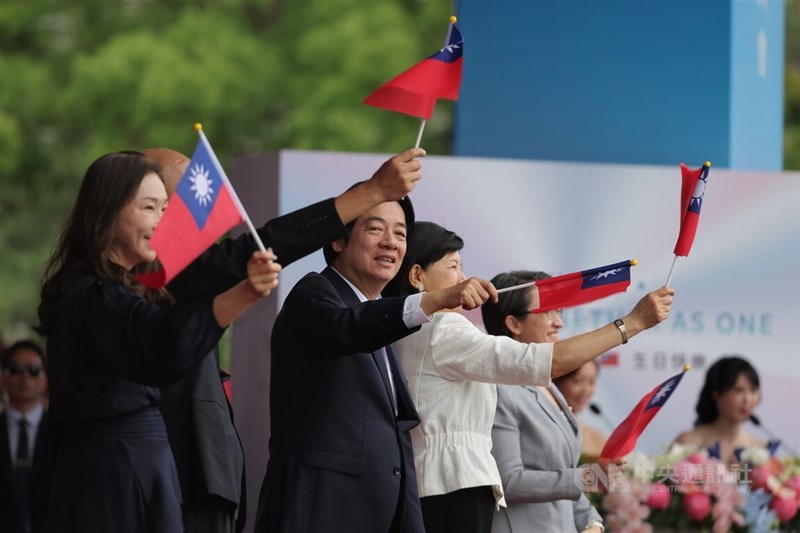 President Lai Ching-te (center) waves a national flag during National Day celebrations in front of the Presidential Office in Taipei on Saturday. CNA photo Oct. 10, 2026 