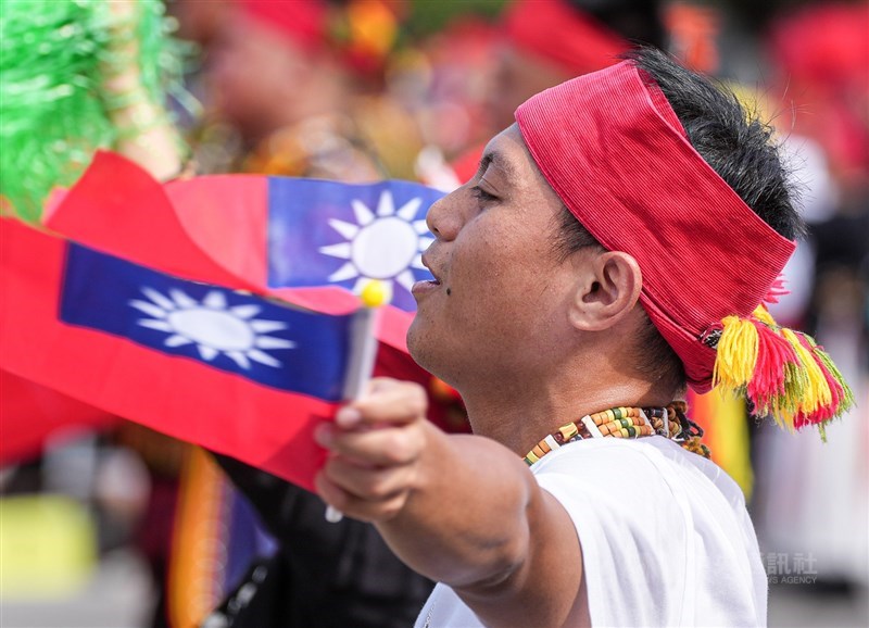 A man wave the ROC national flag during a warm-up performance at the National Day celebration in front of the Presidential Office in Taipei on Saturday. CNA photo Oct. 10, 2026