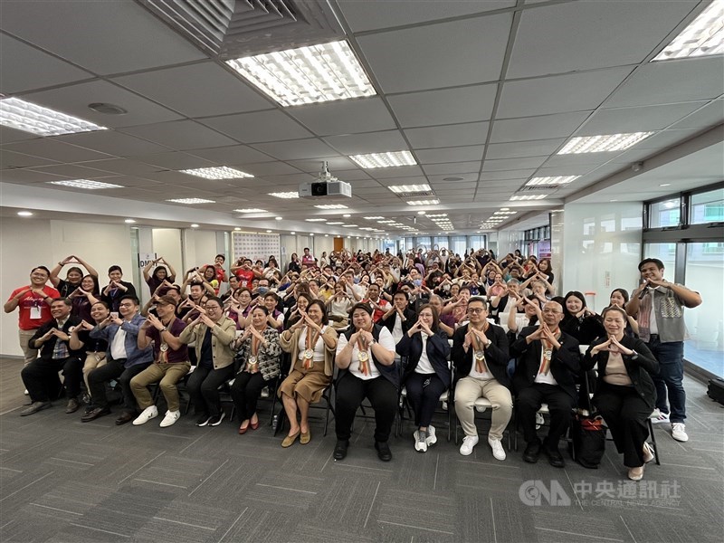Philippine officials, Filipino migrant workers and other guests pose for a group photo at the opening of the OFW Global Center–Taipei on Sunday. CNA photo Oct. 11, 2026