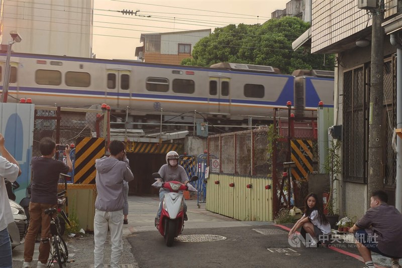 People take photos of the original landscape around Tainan Station on Tuesday before it disappears as the railway is moved underground. CNA photo Oct. 13, 2026