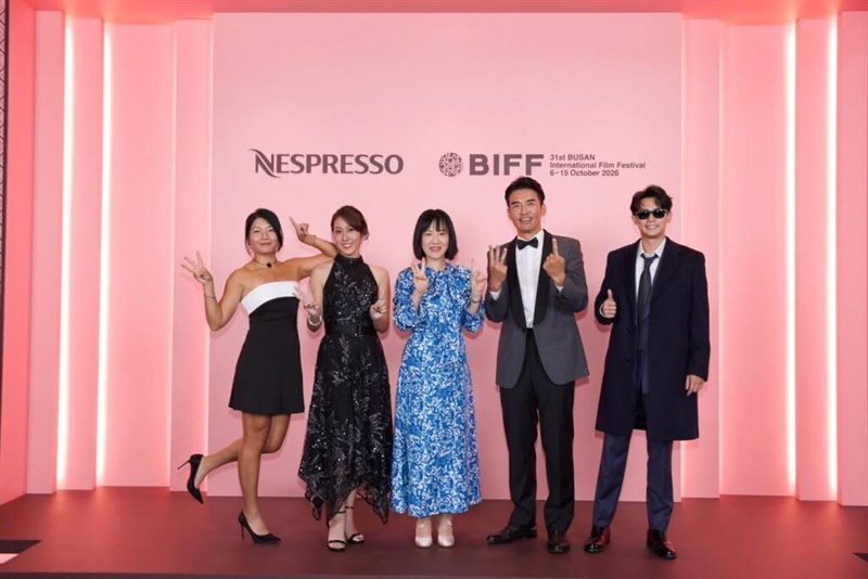 The film crew of "To Be Ordinary," including Taiwanese director Lee Yun-chan (center), pose before walking the red carpet at the Busan International Film Festival on Oct. 11. Photo courtesy of the film's Facebook page