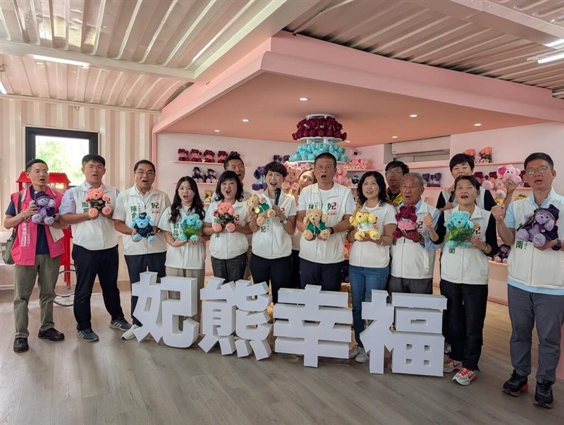 The Democratic Progressive Party's Tainan mayoral candidate Chen Ting-fei (center, holding microphone) poses with her series of campaign merchandise. Photo courtesy of Chen Ting-fei's office Oct. 18, 2026