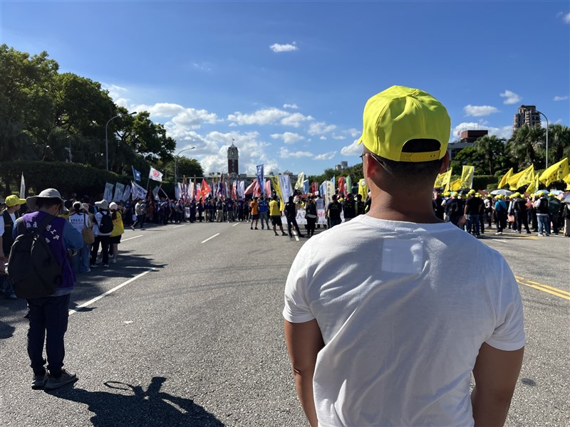 Chunghwa Telecom engineer Paul Chen (a pseudonym) attends a labor rally in Taipei on Monday, photographed from behind at his request over concerns about possible employer retaliation. CNA photo Oct. 19, 2026