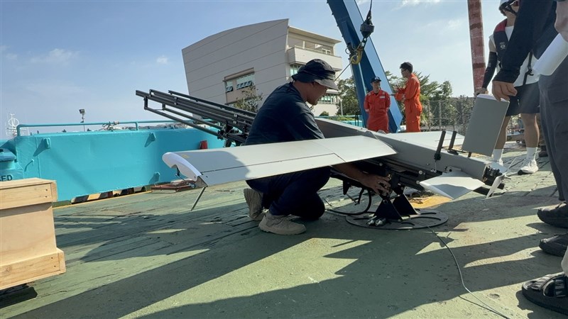 A man positions a drone on a launch catapult. Photo courtesy of the OAC