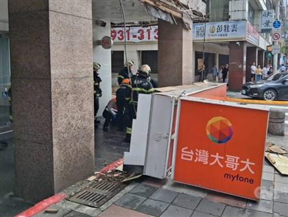 Falling telecom storefront sign injures two in Taipei