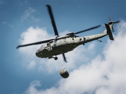 Black Hawk helicopter airlifts fuel bladder in battlefield resupply exercise