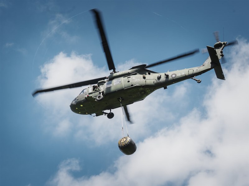 Black Hawk helicopter airlifts fuel bladder in battlefield resupply exercise