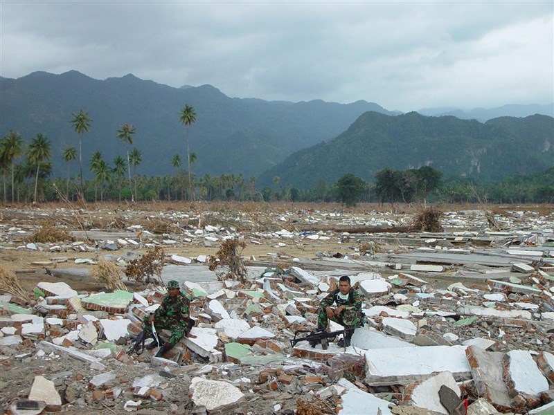 Sejumlah tentara duduk di atas reruntuhan di Aceh pada 3 Januari 2005, setelah tsunami menghantam pada 26 Desember 2024. (Sumber Foto : Dokumentasi CNA)