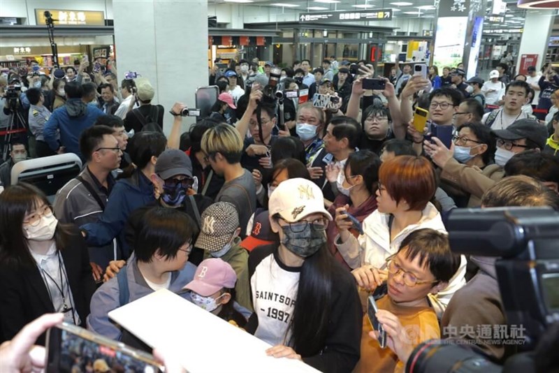 Liu Zhenya (di tengah depan, mengenakan topi putih) berada di Bandara Songshan Taipei pada Selasa, bersiap untuk naik pesawat menuju Tiongkok. (Sumber Foto : CNA, 25 Maret 2025)