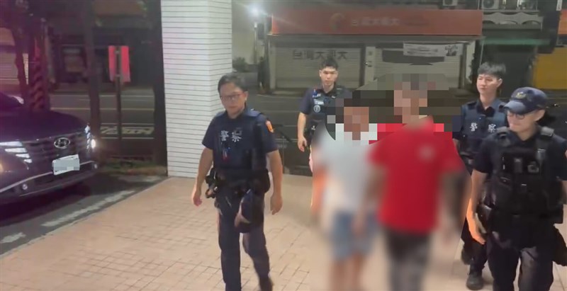 Petugas polisi Tainan mengawal para tersangka di trotoar pada hari Kamis setelah tiga pria ditangkap karena melempar telur dan menaburkan kertas sembahyang di kediaman seorang pengasuh anak yang anak asuhnya telah meninggal. Foto milik Biro Kepolisian Kota Tainan