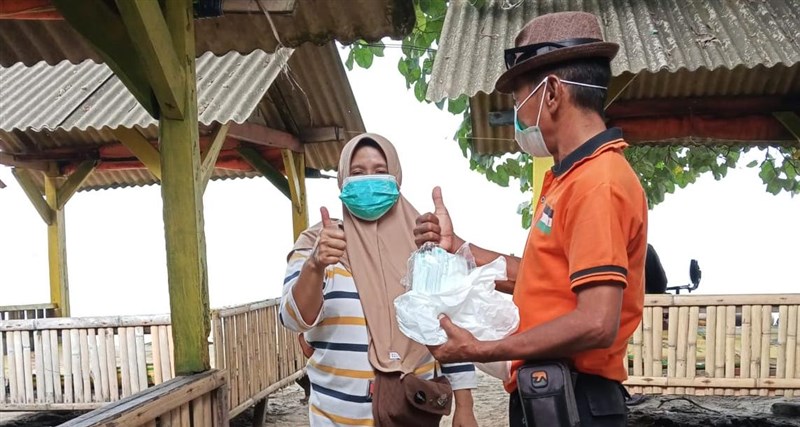 Personel BPBD Kabupaten Serang membagikan masker kepada masyarakat sebagai upaya perlindungan dari paparan abu vulkanik Gunung Anak Krakatau, Minggu. (Sumber Foto : BPBD Kabupaten Serang)