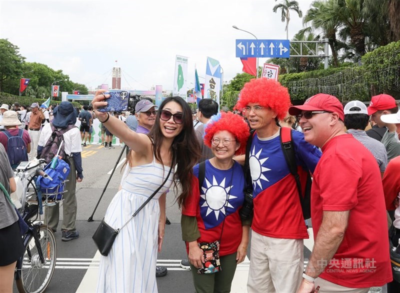Sebuah pawai besar untuk merayakan ulang tahun ke-115 Republik Tiongkok diadakan pada tanggal 10 Oktober di Gedung Kantor Kepresidenan. Orang-orang yang mengenakan pakaian bergambar bendera nasional berpose untuk foto di Boulevard Ketagalan. (Sumber foto: CNA, 10 Oktober 2016)