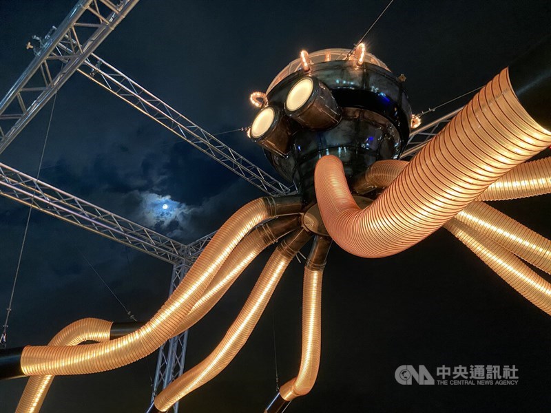 高雄港に設置された屋外アートを見下ろすスーパームーン。月明かりが厚い雲を貫く＝中央社記者董俊志撮影、2022年7月13日