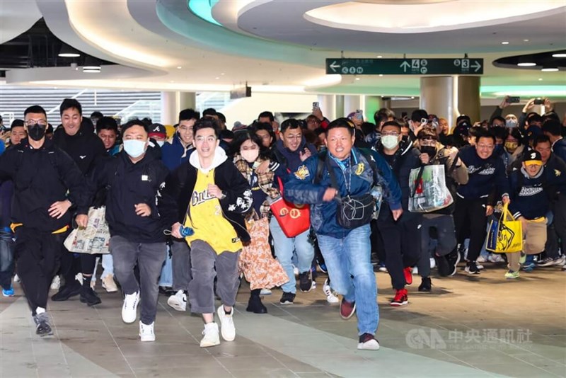 限定商品を手に入れるべく、走ってドームに入る観客=2024年3月2日、中央社記者王騰毅撮影