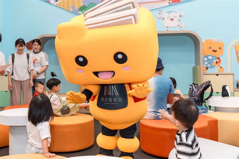 国家档案館のマスコット「阿凱将小屋」と戯れる子供たち＝国家発展委員会档案管理局提供