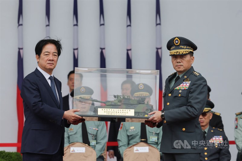 M1A2T戦車部隊の発足式で陸軍司令の呂坤修上将(大将、右)から戦車の模型を受け取る頼総統=10月31日、新竹県