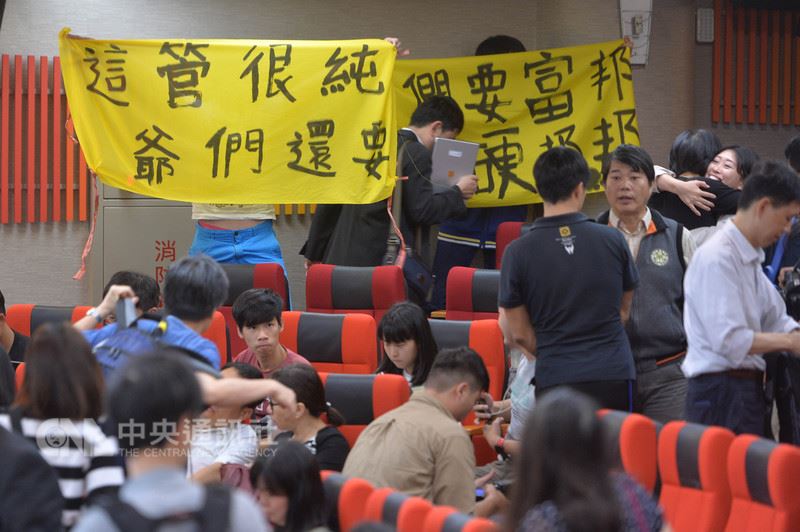 教育部日前駁回台大校長遴選結果,台大12日召開臨時校務會議討論後續因應,最終經投票表決,將要求教育部儘速發聘。結果出爐後,會議現場有部分學生拉起布條表達立場。中央社記者孫仲達攝 107年5月12日