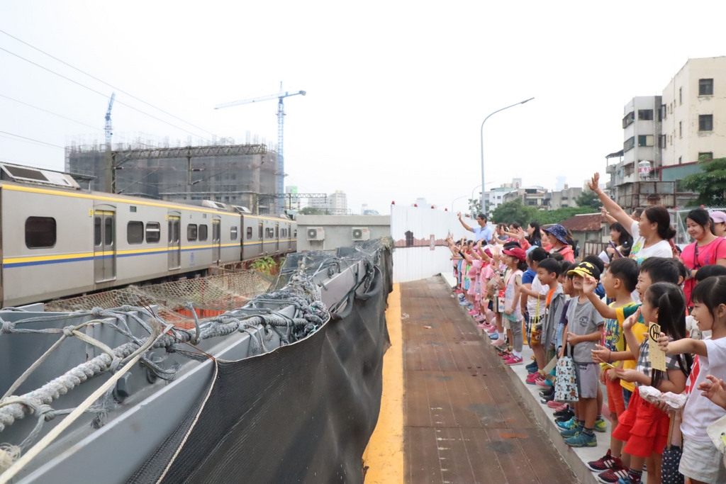 台鐵高雄新左營站至鳳山站鐵道將走入歷史,全面鐵路地下化,14日通車,緊鄰鐵道的高雄市三民國小校園後方鐵道上火車行駛畫面將不復見,師生12日在校園揮別通過校園後方火車的最後身影。(高市教育局提供) 中央社記者程啟峰高雄傳真 107年10月12日