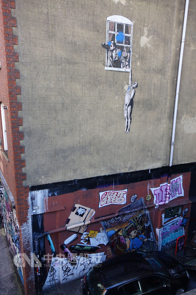 英國塗鴉大師班克西的作品Hanging man,位在建築物牆面上相當高的位置,從旁邊的陸橋上看去特別顯眼。中央社記者戴雅真布里斯托攝 108年1月19日