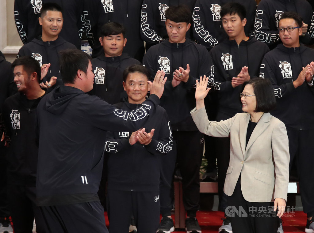 總統蔡英文(前右)20日在總統府接見「2018年中華職棒總冠軍Lamigo桃猿隊」,球員進場時,蔡總統逐一擊掌致意。中央社記者張新偉攝 108年3月20日