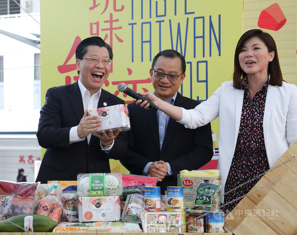 新加坡職總平價合作社「台灣食品節」開幕,駐新加坡代表梁國新(左)向消費者推薦台灣啤酒。中央社記者黃自強新加坡攝 108年3月21日