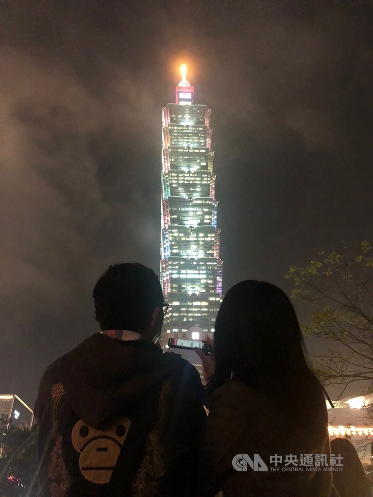 今年元宵節,街頭民眾欣賞達兩分半鐘的台北101燈光秀。(中央社檔案照片)