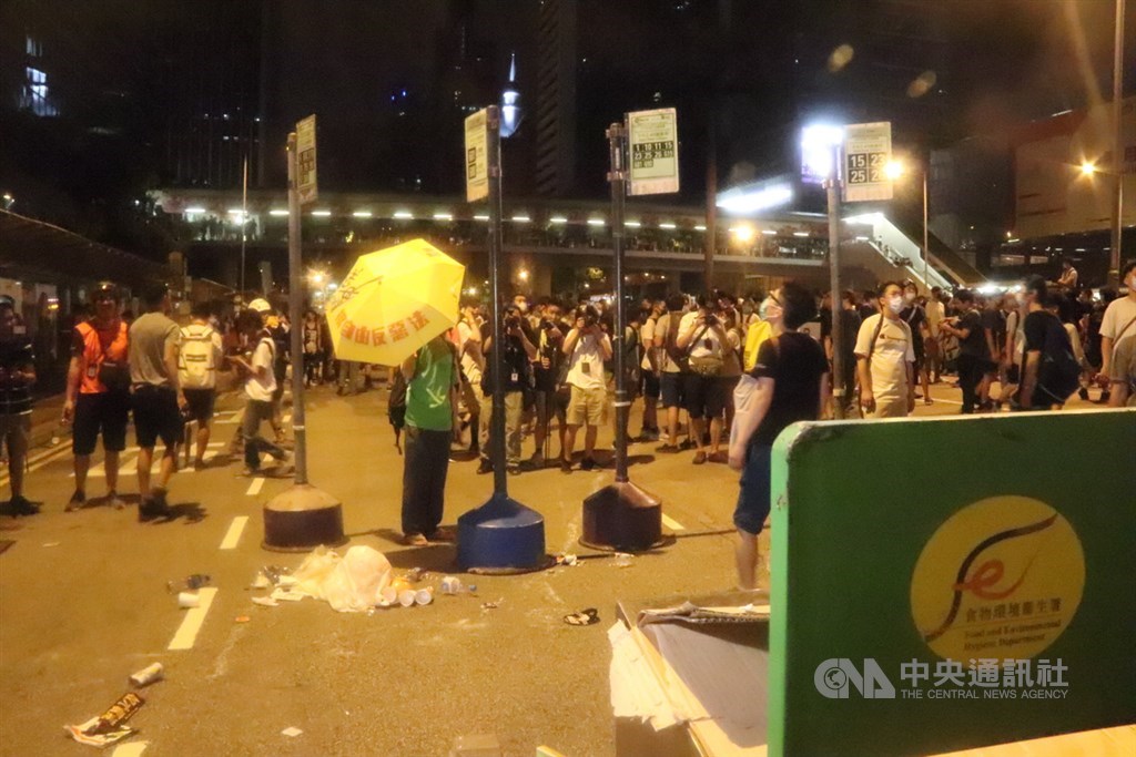 香港「反送中」遊行9日晚間結束後,數百名年輕示威者10日凌晨占據灣仔告士打道往來行車線,以垃圾桶和公車站牌堵塞,重演「占中」景況。中央社記者張謙香港攝108年6月10日