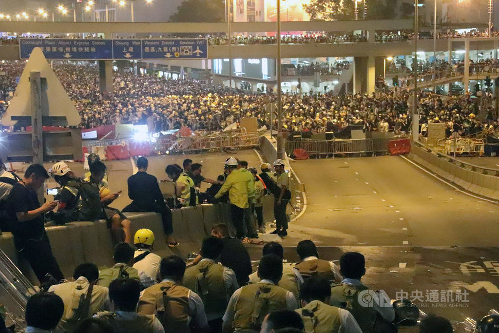 12日前往香港立法會前抗議逃犯條例修訂的民眾,在下午遭警方驅離後,晚間9時過後已轉往不遠處的中環鬧區,繼續與防暴警察對峙。警方目前已暫停清場行動。中央社記者張謙香港攝 108年6月12日