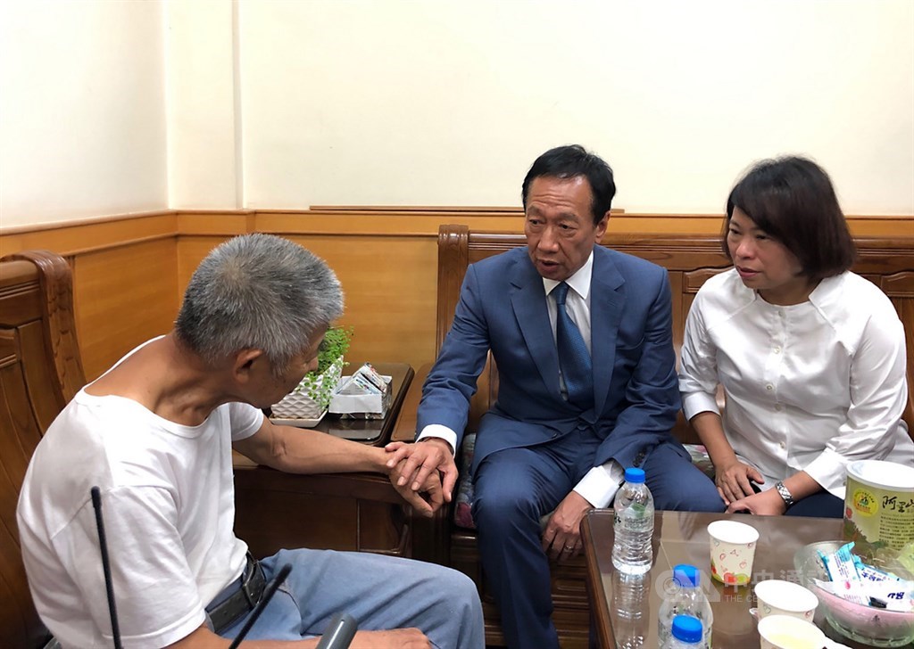 國民黨總統初選參選人郭台銘(右2)4日下午在嘉義市長黃敏惠(右)陪同下,前往嘉義市立殯儀館慰問殉職鐵路警察李承翰的父親(左)。中央社記者黃國芳攝 108年7月4日