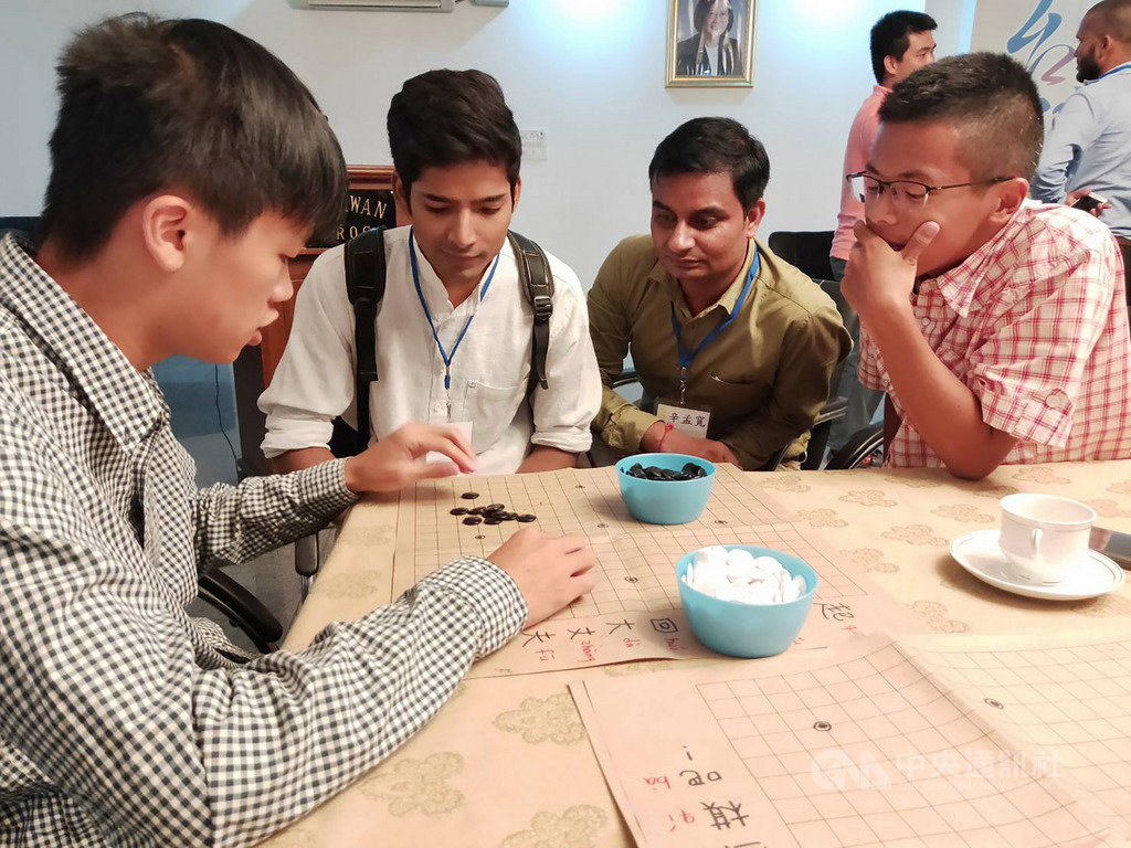 政大國際志工團體拼青春團隊團員、台中一中學生梁皓程(左)23日在駐印度代表處與印度國立伊斯蘭大學學生交流時,傳授圍棋,雙方聚精會神。(駐印度代表處教育組提供)中央社記者康世人新德里傳真 108年8月23日