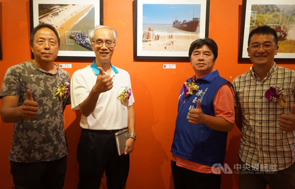 金門縣文化局與金門縣攝影學會共同舉辦「戰地.讚地」攝影聯展,即日起展出至9月5日,作品「協力運補」讓攝影學會理事長許進西(左起)、文化局長許正芳等人看了很有感。中央社記者黃慧敏攝 108年8月25日