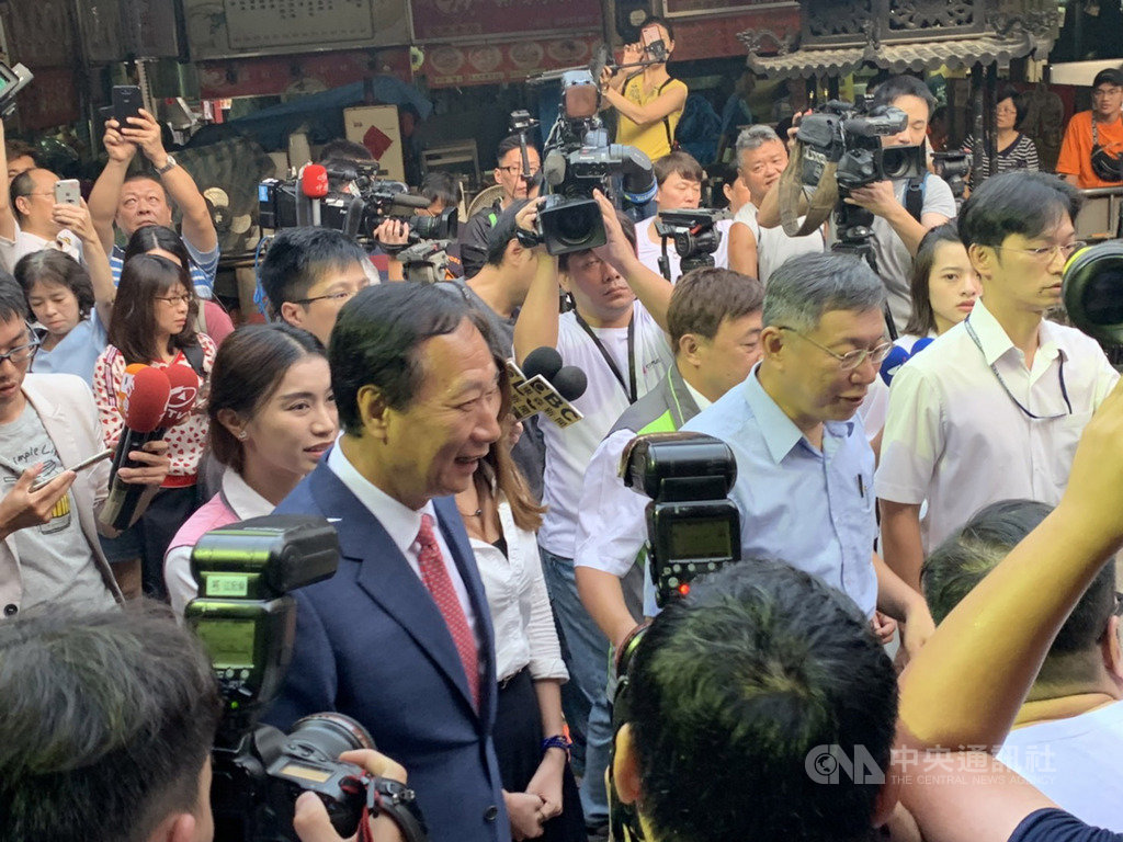 台北市長柯文哲(前右2)與鴻海創辦人郭台銘(前左)11日到新竹都城隍廟參拜,大批媒體聚焦。中央社記者郭宣彣攝 108年9月11日