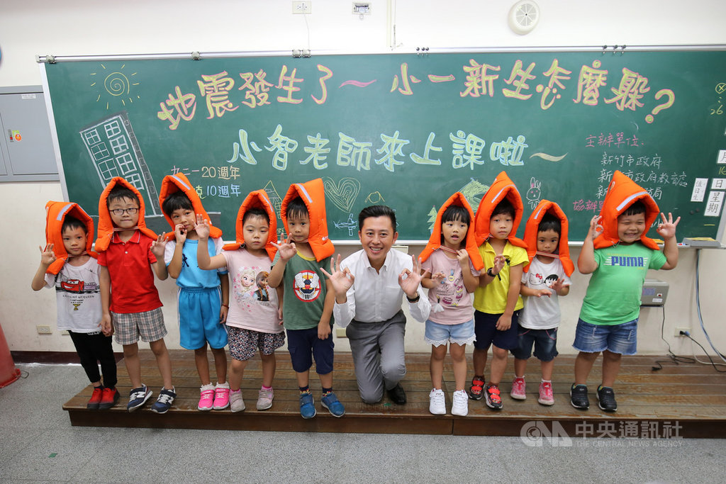 新竹市長林智堅(右5)16日到大庄國小陪伴學童演練地震緊急避難,並教導孩童「趴下、掩護、穩住」地震保命3要領。(新竹市消防局提供)中央社記者魯鋼駿傳真 108年9月16日
