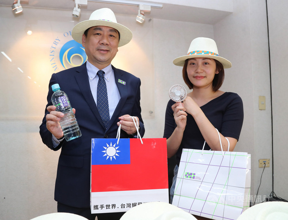 108年國慶大會禮賓袋24日搶先亮相,慶籌會秘書長陳宗彥(左)展示今年禮賓袋並介紹內容物,包括紳士帽、濕紙巾、小電扇、瓶裝水與國慶主視覺徽章等。中央社記者張皓安攝 108年9月24日