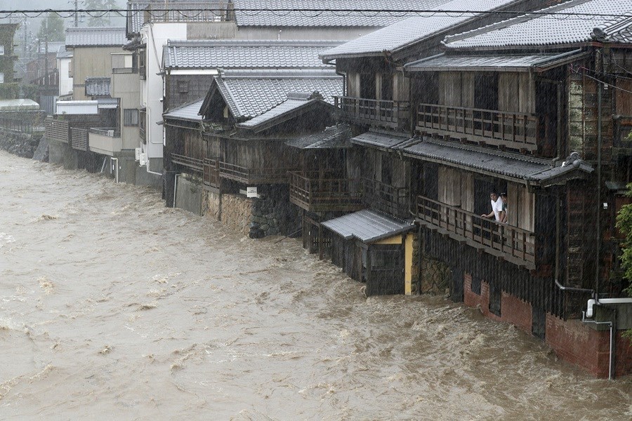 颱風哈吉貝帶來雨勢造成日本三重縣五十鈴川水位氾濫,伊勢市住宅整排泡在水中。(共同社提供)