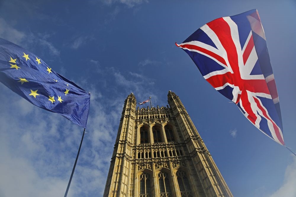 歐洲聯盟和英國17日宣布達成新的英國脫歐協議,雙方同意未來將致力達成雄心勃勃的自由貿易協議,取消關稅和配額限制。圖為倫敦維多利亞塔前的英國國旗及歐盟旗幟。(法新社提供)