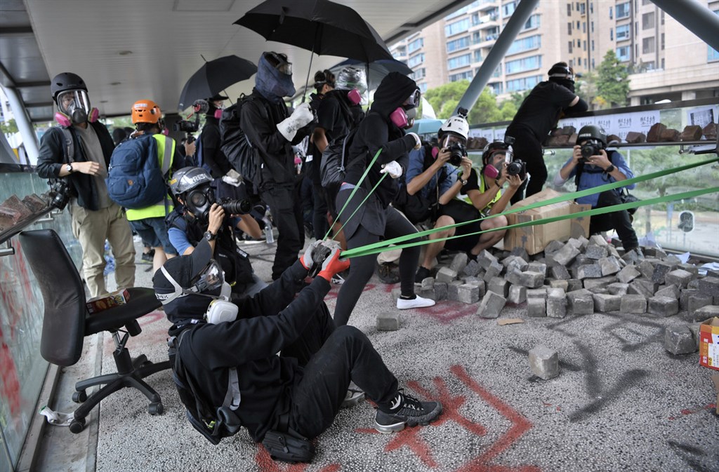 反送中示威者12日上午集結於香港歌和老街近城市大學學生宿舍一段,警方到場驅散時,在橋上的示威者以大型彈弓向警員發射石塊並丟擲汽油彈。(中通社提供)中央社 108年11月12日
