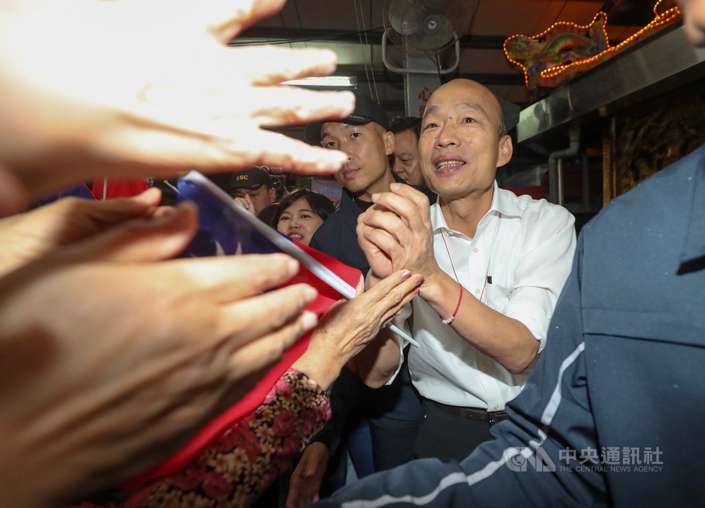 國民黨總統參選人韓國瑜(右)18日晚間到台北內湖桂竹宮參香,與力拚連任的黨籍立委李彥秀同台造勢,受到支持者熱情歡迎。中央社記者裴禛攝 108年11月18日