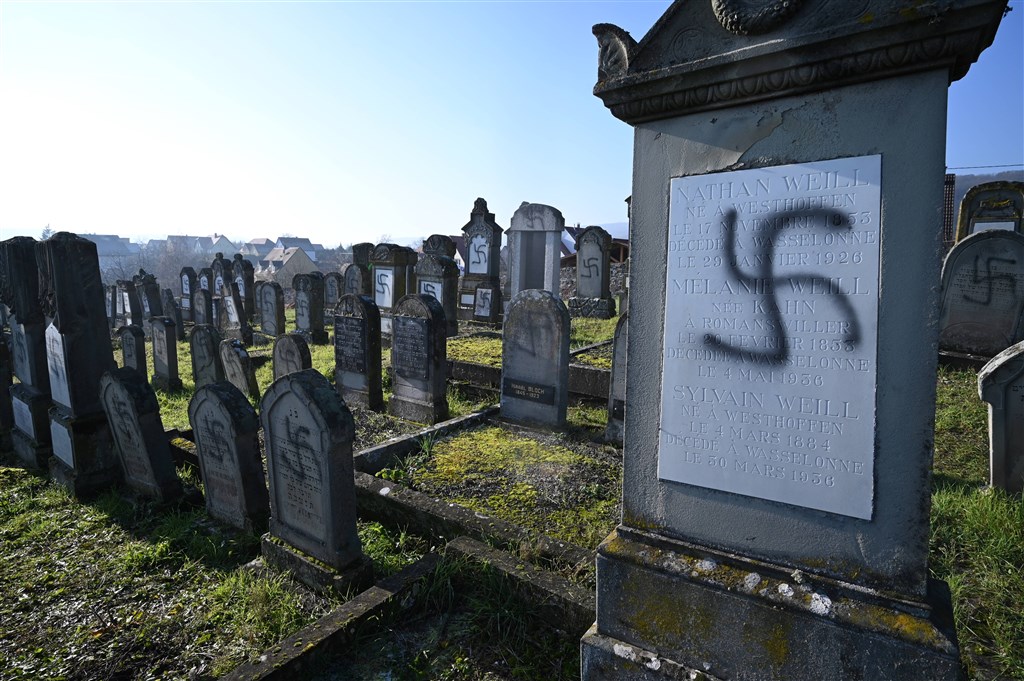 法國東部大城史特拉斯堡附近一個猶太墓園裡,107座墳墓遭人畫上納粹黨徽等塗鴉,內政部長視察後表示「這是可憎的反猶行為」。(法新社提供)