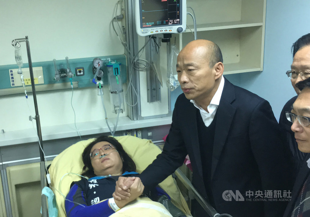 國民黨立委林奕華、陳玉珍(左)6日到外交部抗議,過程中不慎受傷,國民黨總統參選人韓國瑜(中)來到台大醫院探視,韓國瑜緊握著陳玉珍的手,幫她加油打氣。中央社記者劉冠廷攝 108年12月6日