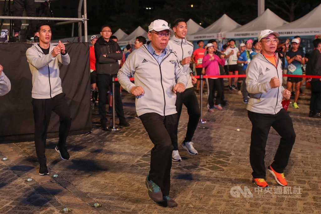 2019台北馬拉松15日在台北市政府前廣場開跑,台北市長柯文哲(前中)、田徑好手楊俊瀚(後排左)、陳傑(後排右)出席與會,在賽前與跑者一起做操熱身。中央社記者裴禛攝 108年12月15日